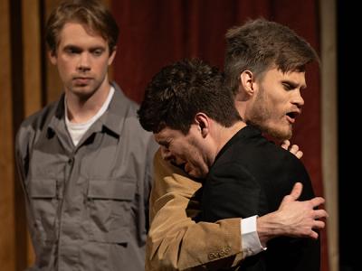 Colby Hull hugs Eli Hilliard as Justin Friesen looks on in emotional scene from "The Moon is Down." (Photo by Jared Hill, οƵ Student Photographer) 